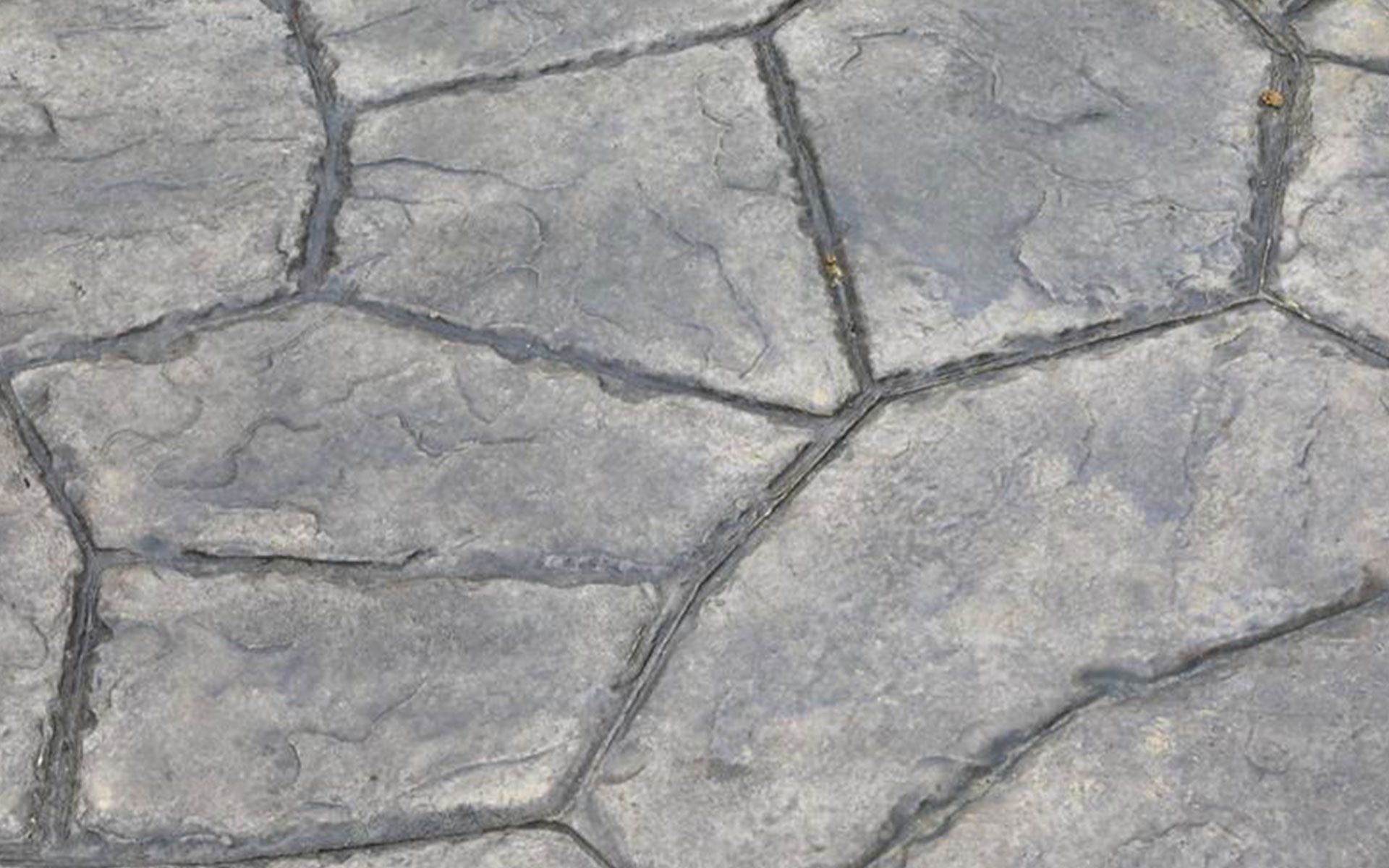 A close up of a gray stone floor with a geometric pattern.