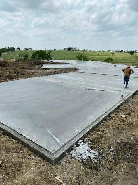 A man is standing on top of a concrete floor.