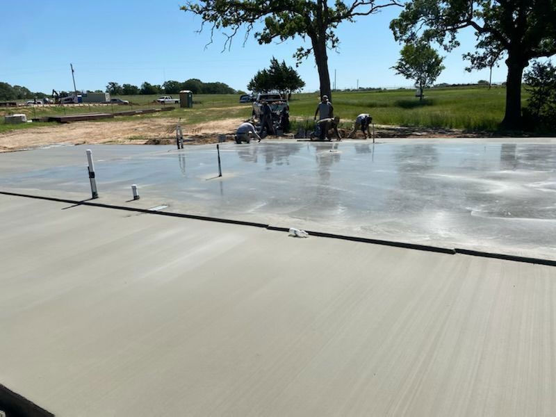 A person is plastering a wall with a trowel.