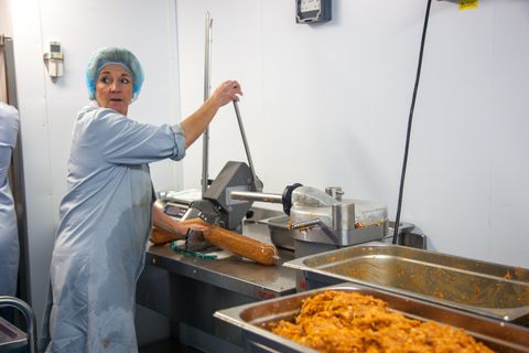 One of the members of the production line has to put the deliciously flavoured meats into skins, it is then sealed and ready to be hung, partially cooked or dried. Delabole, Cornwall.17.11.15