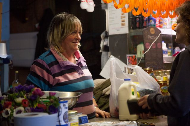 Juliette serves one of her regular costumers at her stall in Perran-ar-worthal, Cornwall. 30.10.15