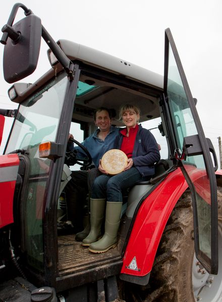 Julie and Trevor Howe in their tractor with one of their cheeses, at their farm in Ponsanooth, Cornwall. 19.10.15