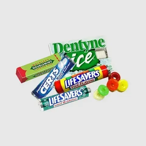 There are many different types of gum and candy on a white background.