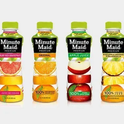 Four bottles of minute maid juice are lined up next to each other