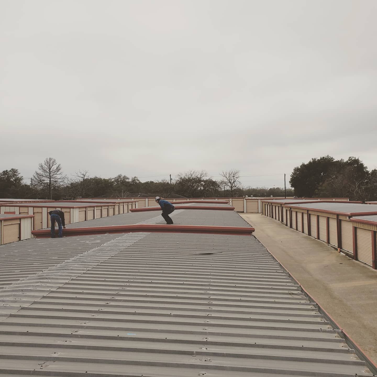 A person is riding a skateboard on the roof of a building.