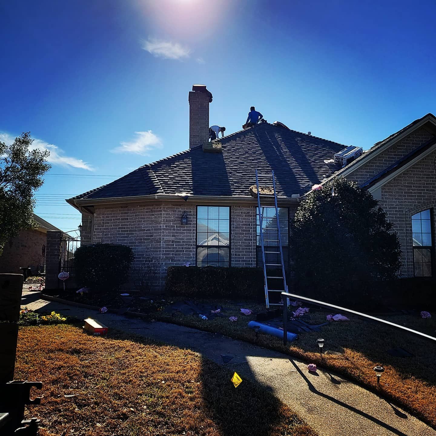 A man is working on the roof of a house