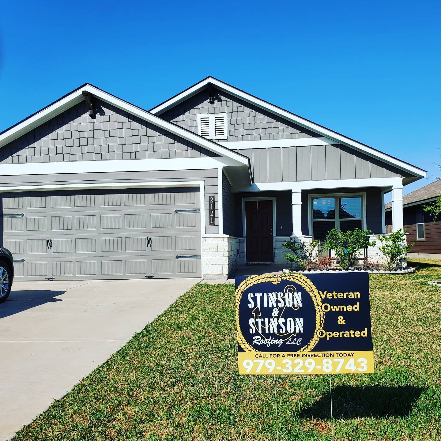 A house with a sign in front of it that says veteran owned and operated