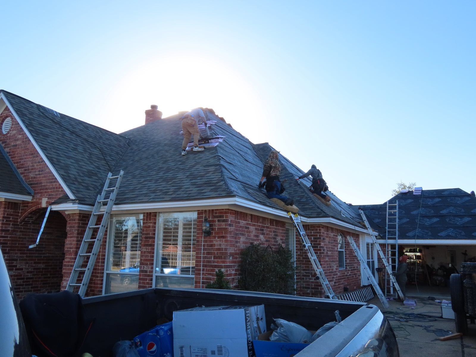 A truck is parked in front of a house that is being remodeled.