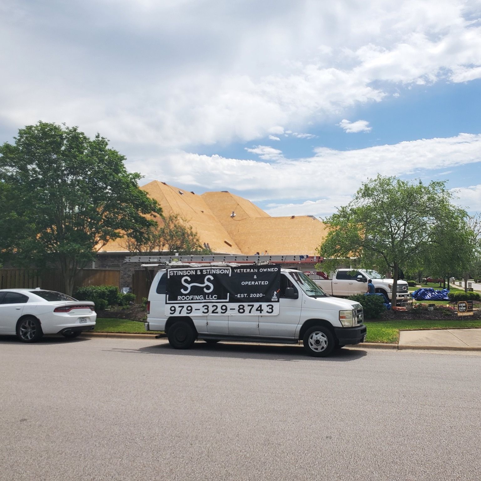 A white van is parked on the side of the road