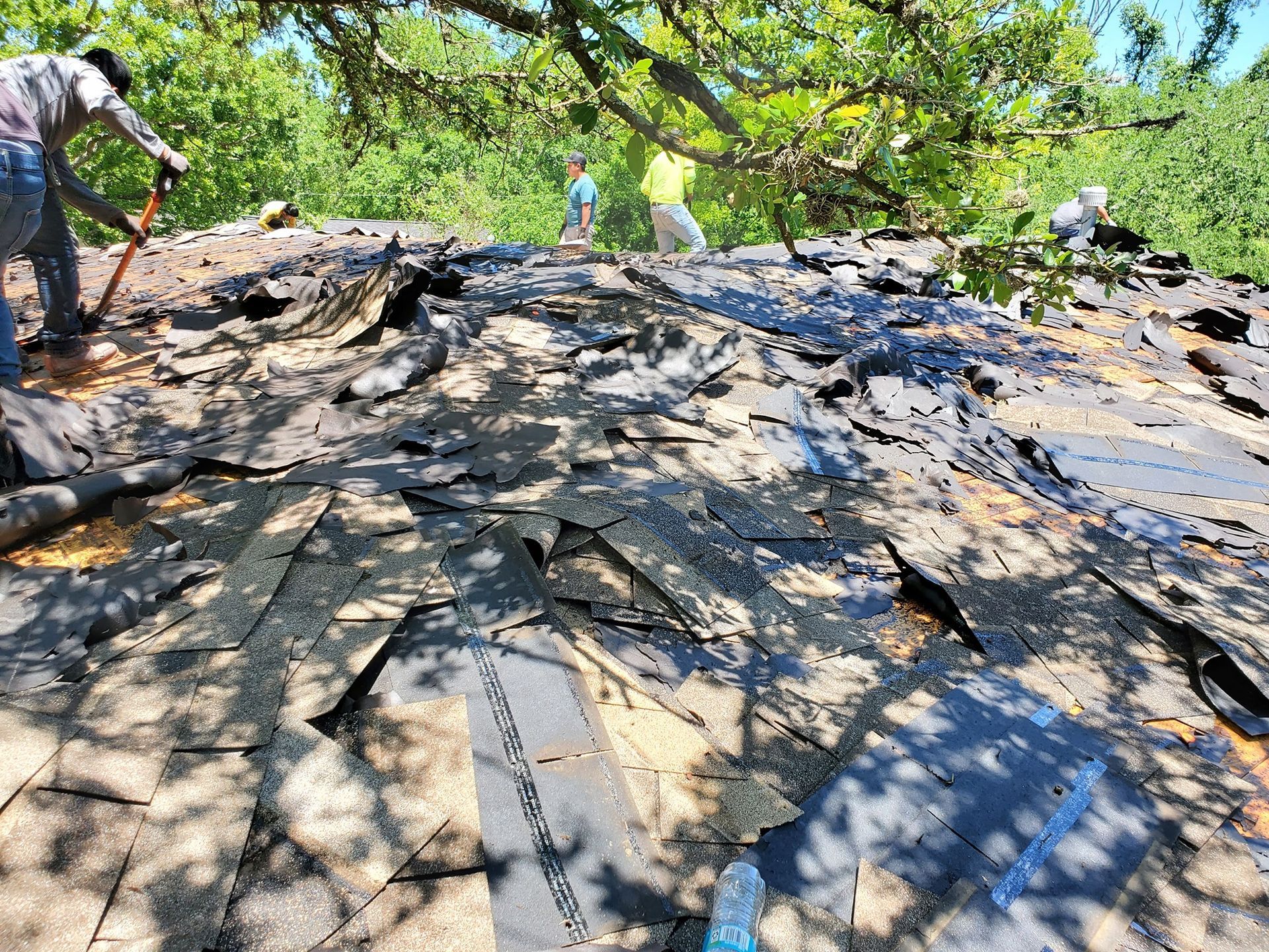 A group of people are working on a roof.