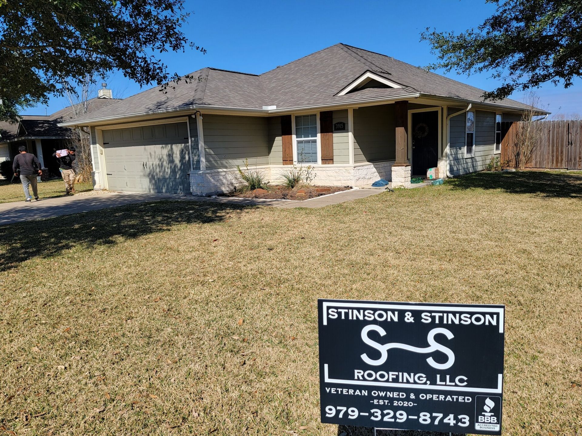 A house with a sign in front of it that says s-s roofing llc.