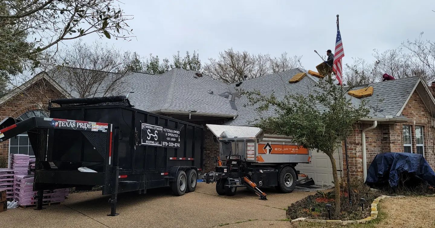 A dump truck is parked in front of a house.