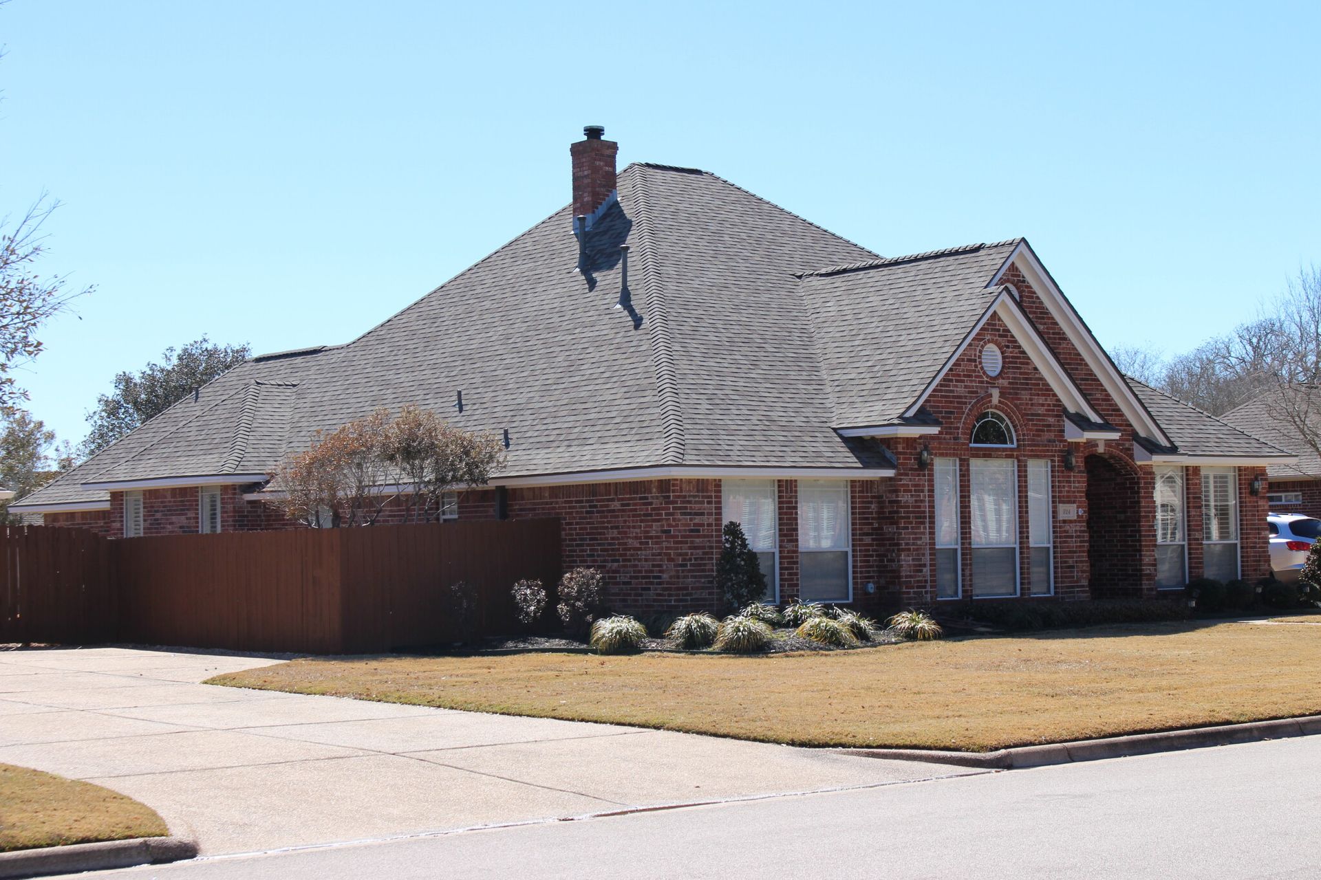 A large brick house with a chimney on the roof