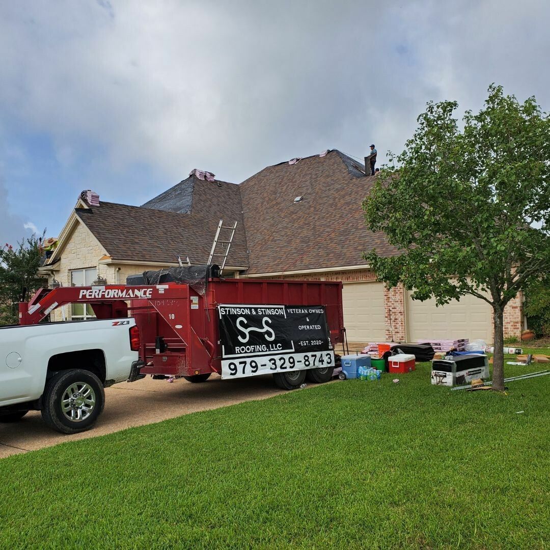 A white truck is parked in front of a house.
