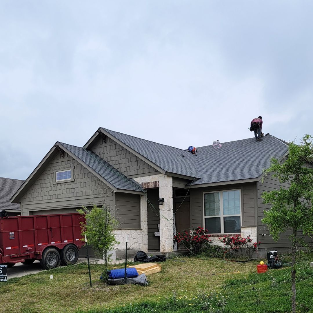 A man is working on the roof of a house.