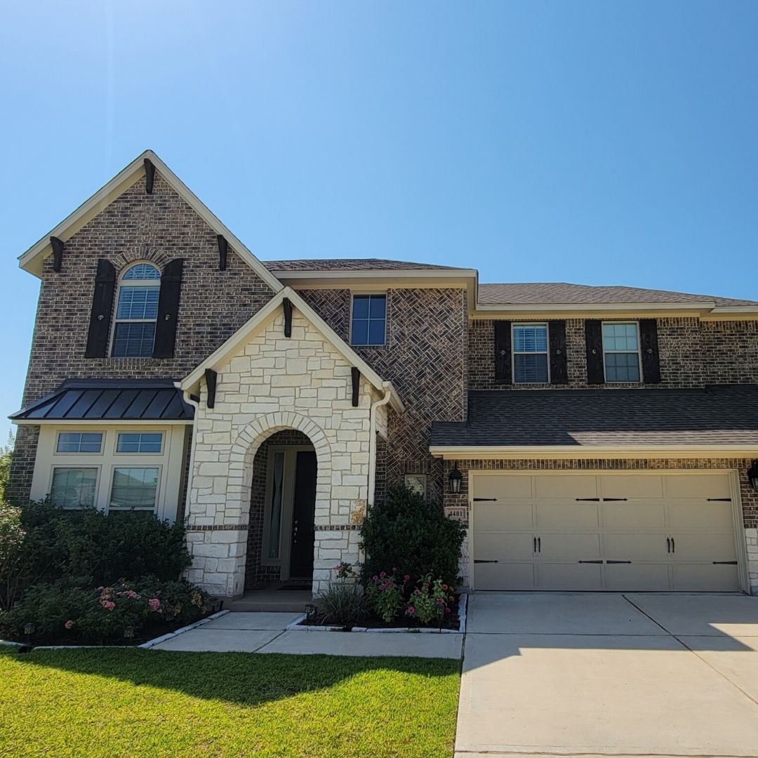 A large brick house with a white garage door