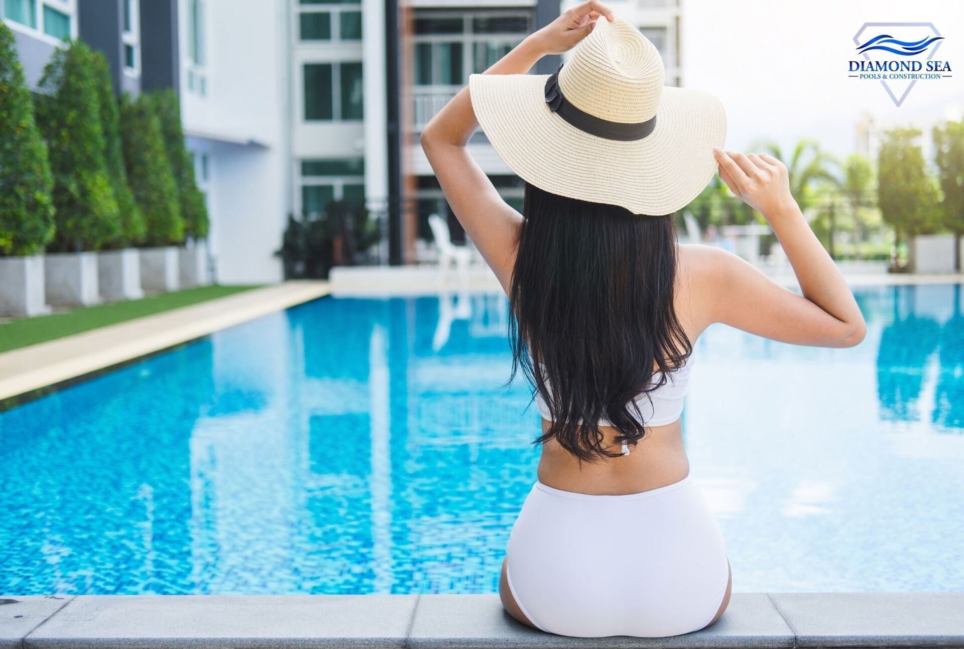 girl in white bikini sitting on the edge of an in ground pool in Austin TX