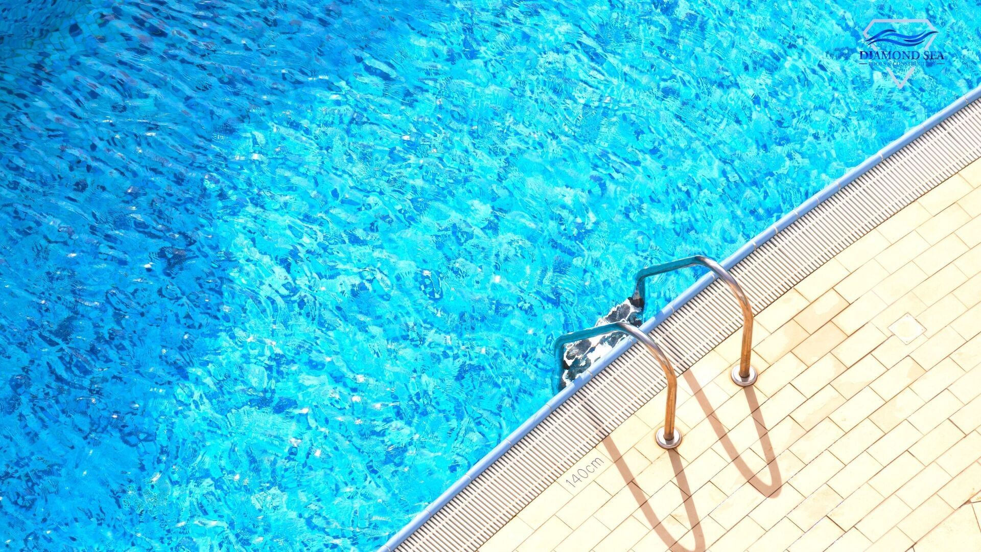 View of an Austin swimming pool from above. Edge of pool with ladder