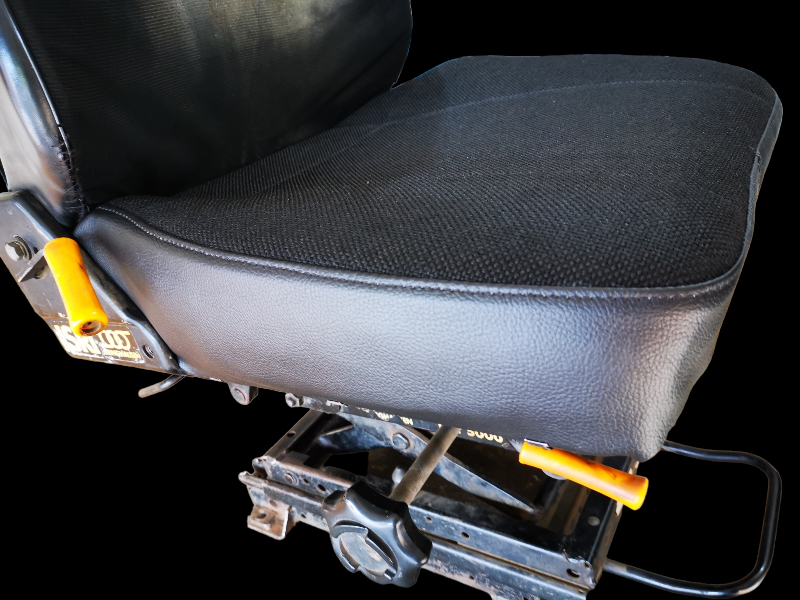 Black vehicle seat with yellow levers and a black base, isolated on black.
