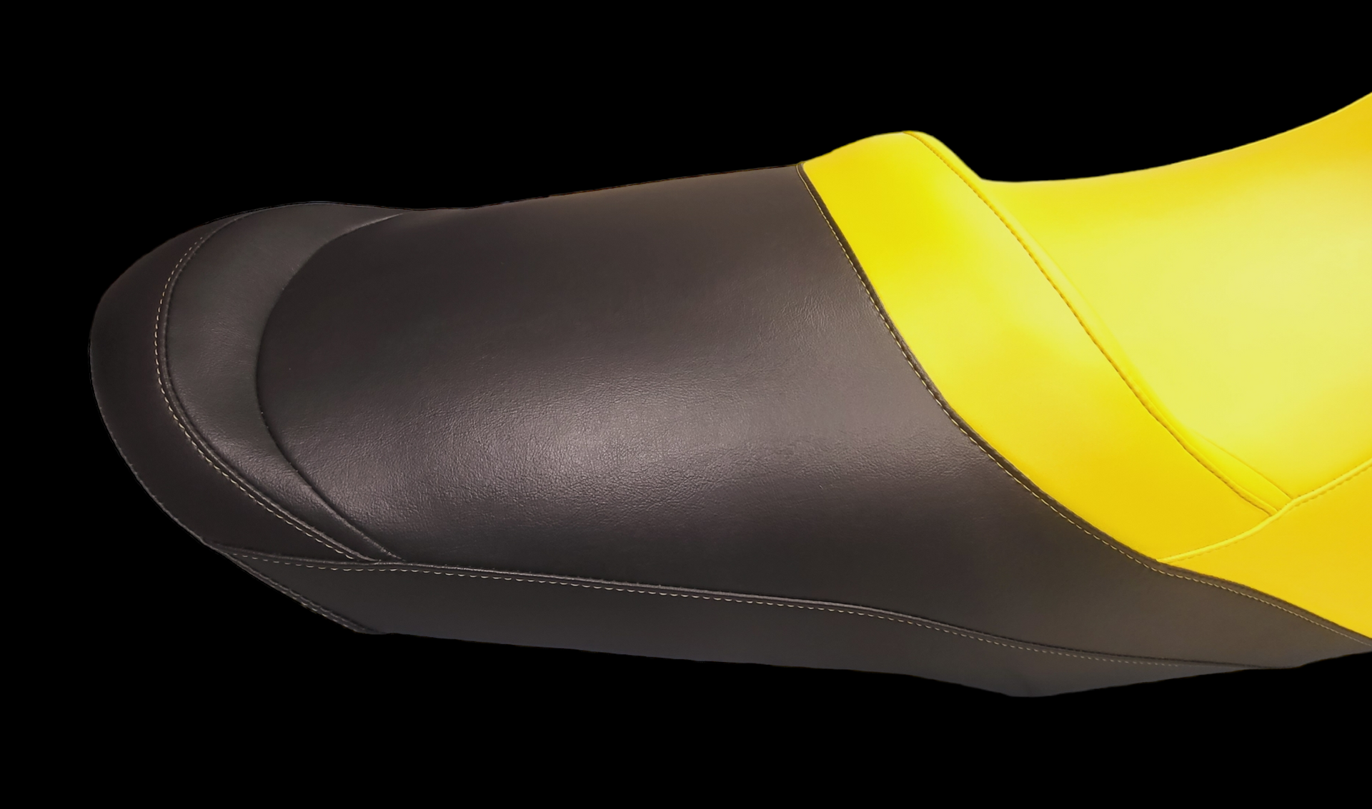 Black toe cap on a yellow boot, stitching visible.