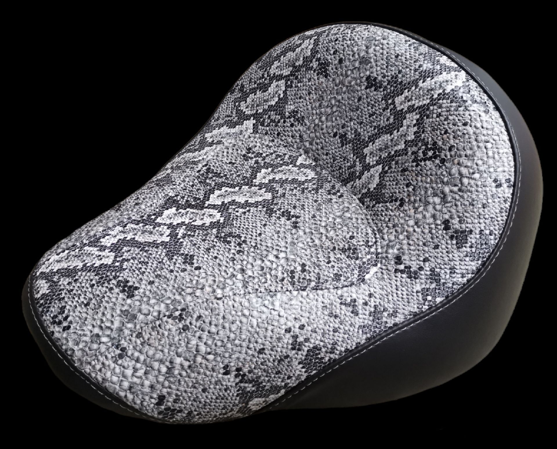 Motorcycle seat, snake skin print with black trim and stitching.