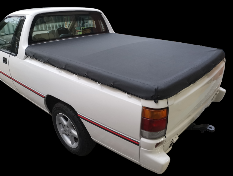 White pickup truck with a black tonneau cover.