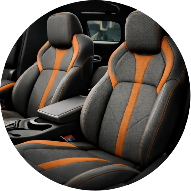 Red and black car seat covers with diamond stitching on a car interior.