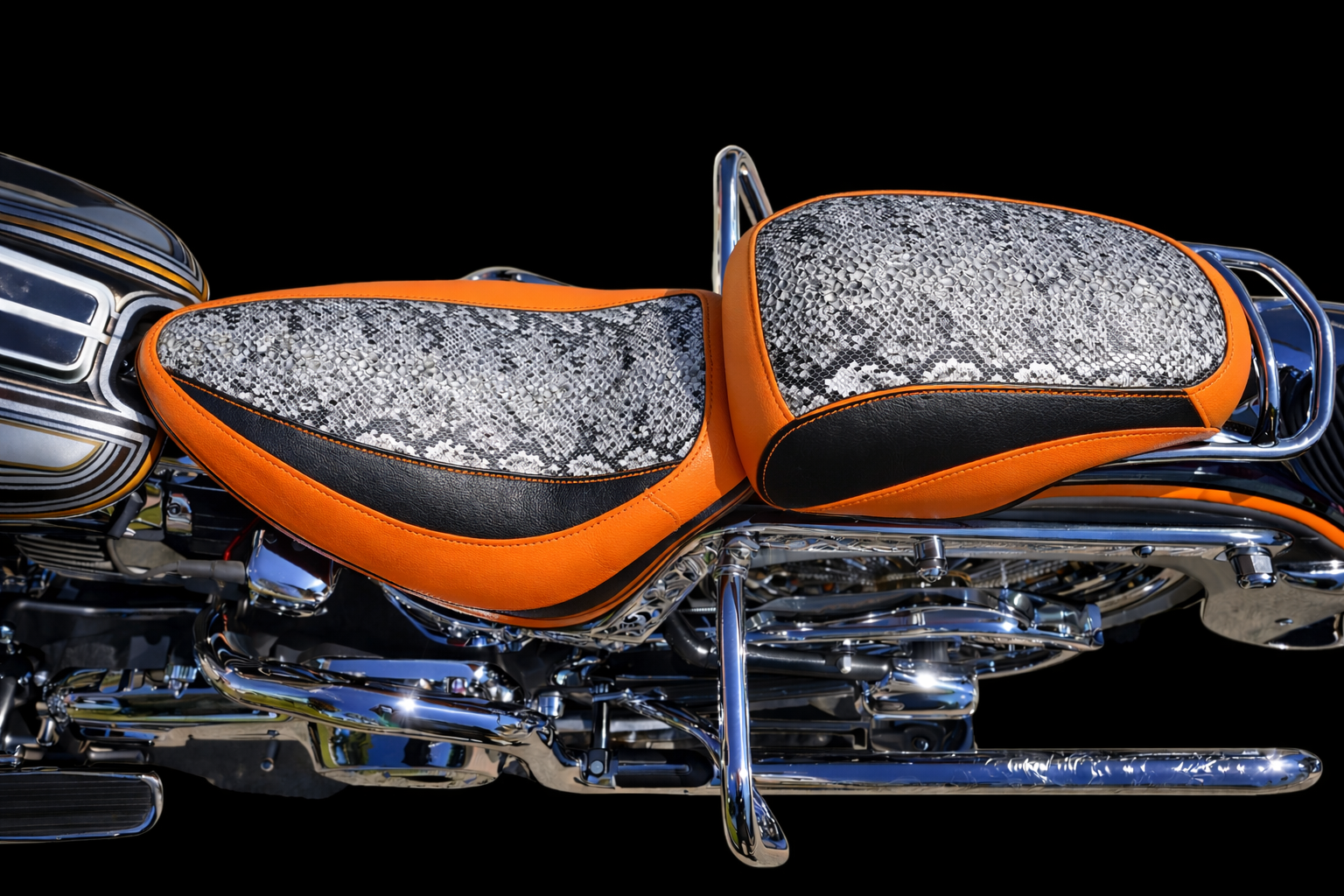 Black quilted motorcycle seat on a gold motorcycle.