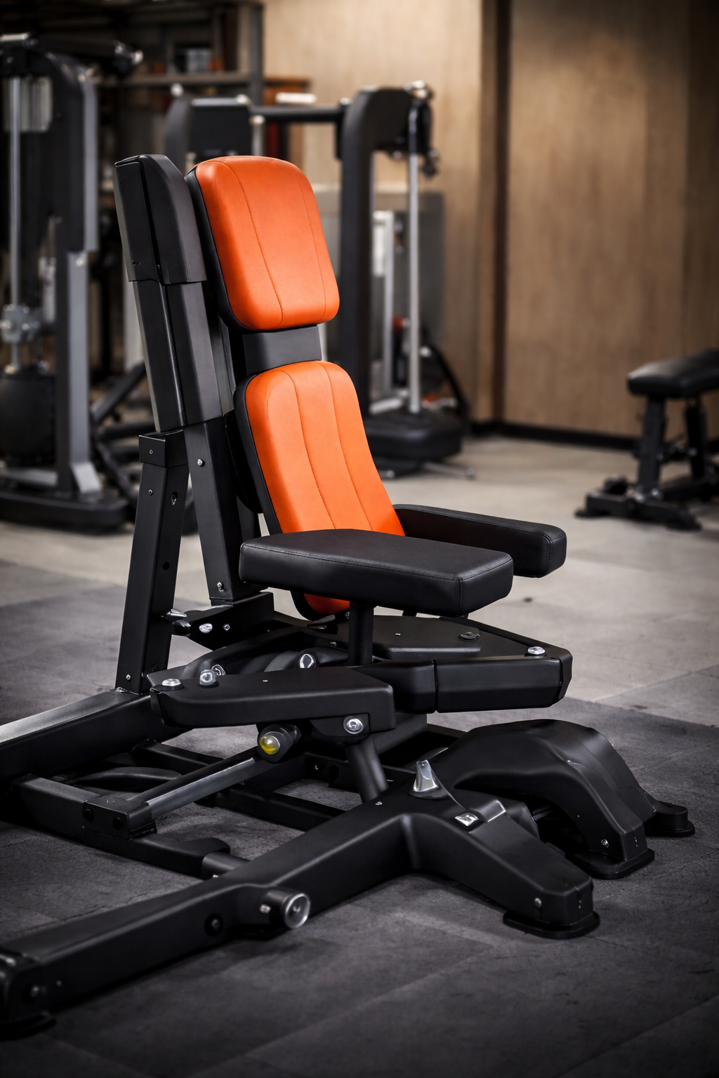Orange and black weight machine in a gym setting.