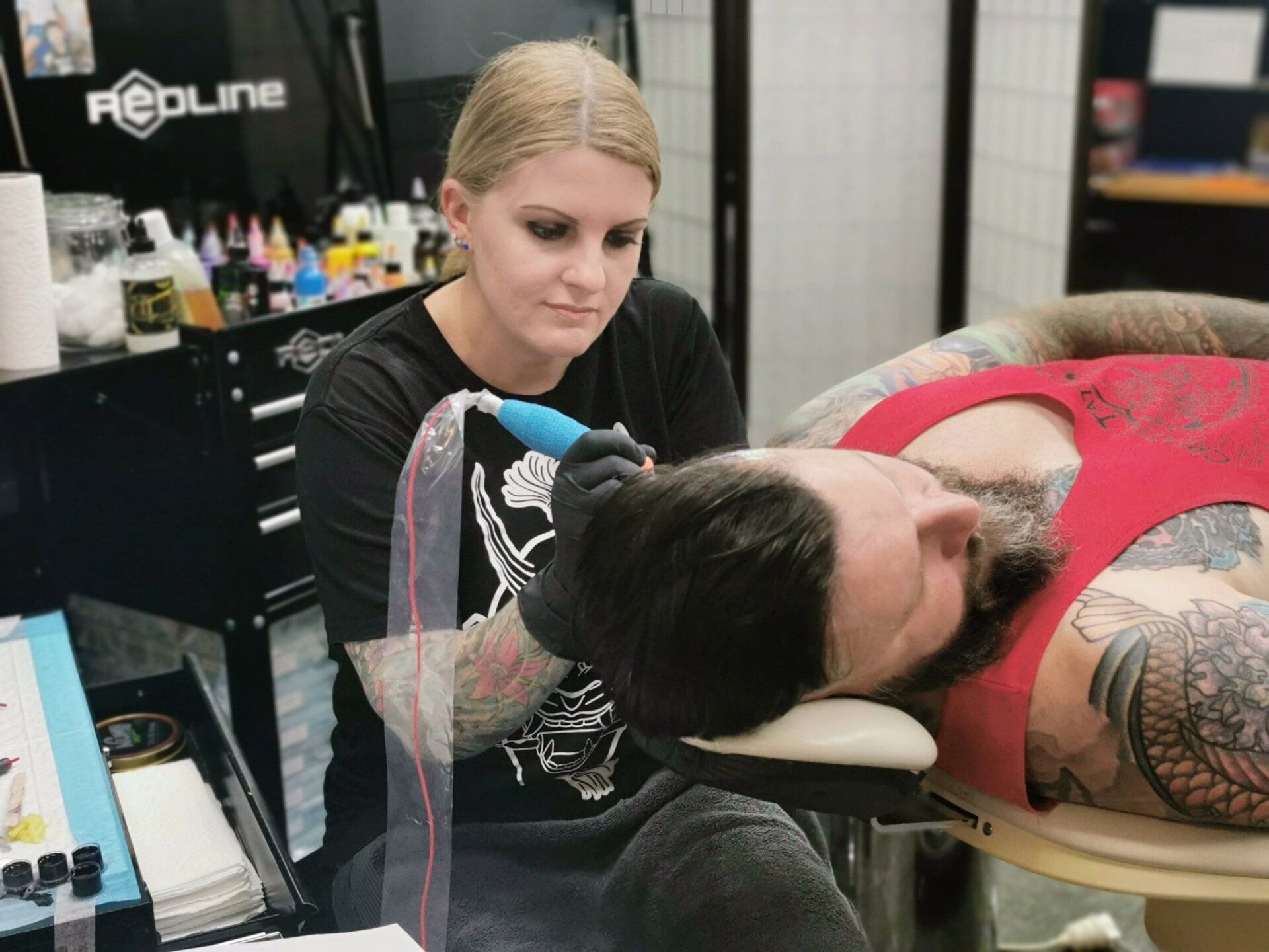 Tattoo Artist working on Neck Tattoo — About Us in South Lismore, NSW