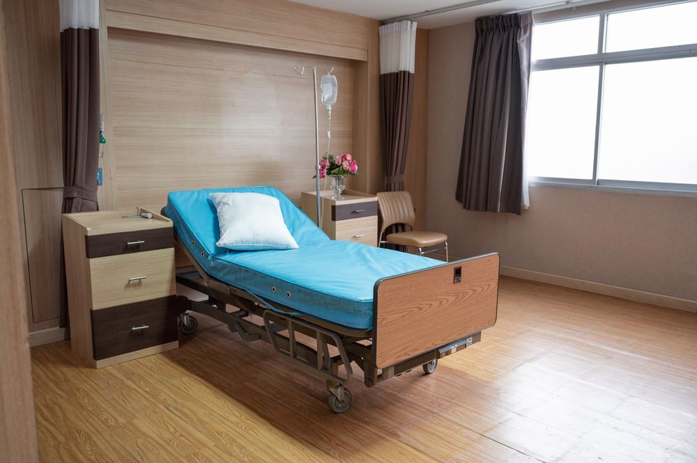 Hospital Room With a Bed, Light Blue Mattress, Brown Wood — Ballina Home Healthcare Sales & Hire and Compression Stockings Plus in Ballina, NSW
