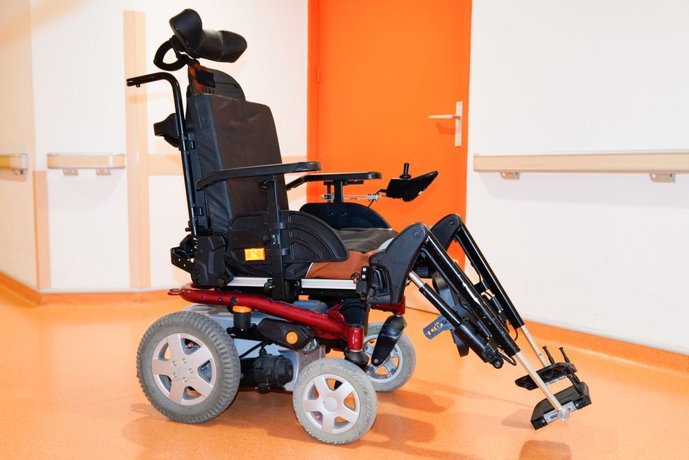 Power Wheelchair in a Hallway With Orange Wall — Ballina Home Healthcare Sales & Hire and Compression Stockings Plus in Ballina, NSW