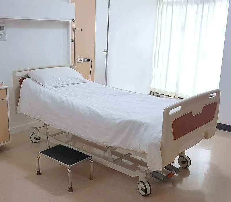 Hospital Bed in a Room With White Linens, a Step Stool — Ballina Home Healthcare Sales & Hire and Compression Stockings Plus in Ballina, NSW