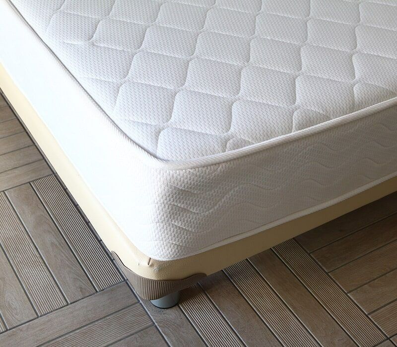 White Mattress on a Light-colored Base With Silver Legs, Resting on a Tiled Floor — Ballina Home Healthcare Sales & Hire and Compression Stockings Plus in Ballina, NSW