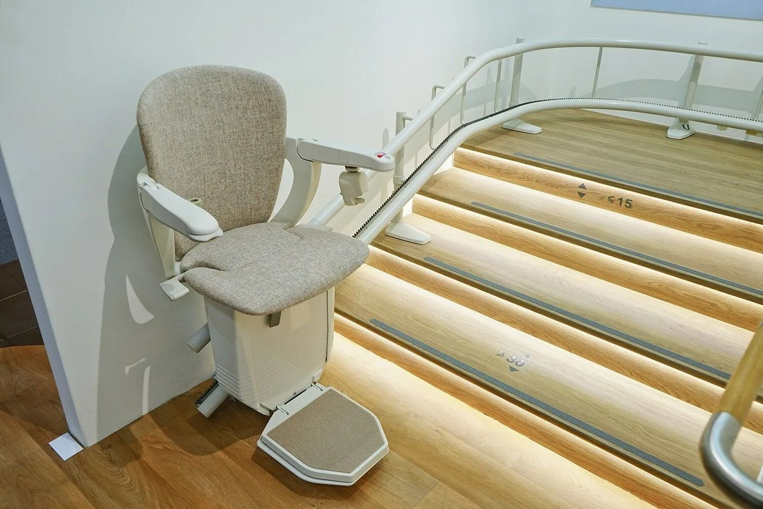 Stairlift Chair on Wooden Steps With a White Rail — Ballina Home Healthcare Sales & Hire and Compression Stockings Plus in Ballina, NSW