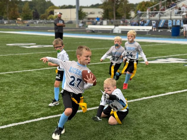 Flag football game with Richmond White carrying the ball against Richmond Blue.