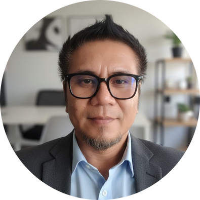 Man with glasses, wearing a dark suit jacket, looking directly at the camera.