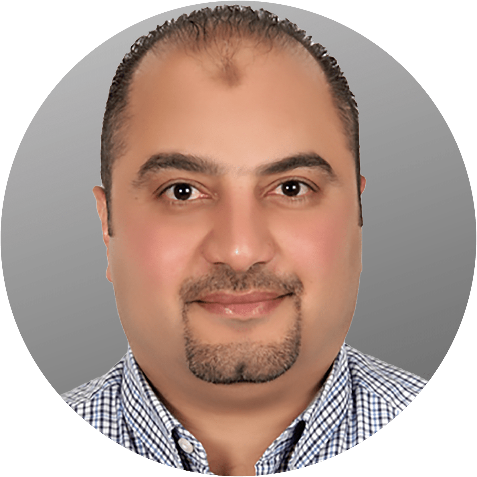 Man with dark hair, goatee, smiling, wearing a patterned shirt, set against a gray background.