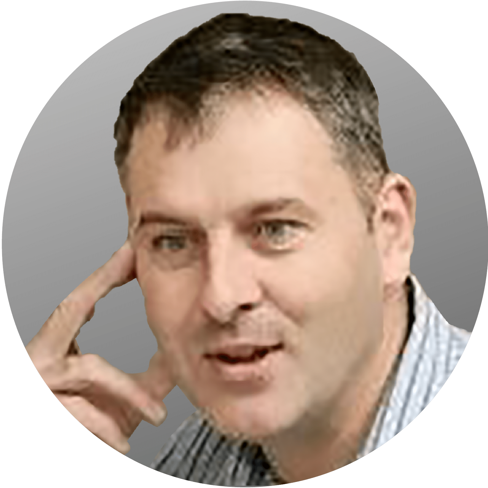 Man with short brown hair, hand on his face, slightly smiling, in front of a gray gradient.