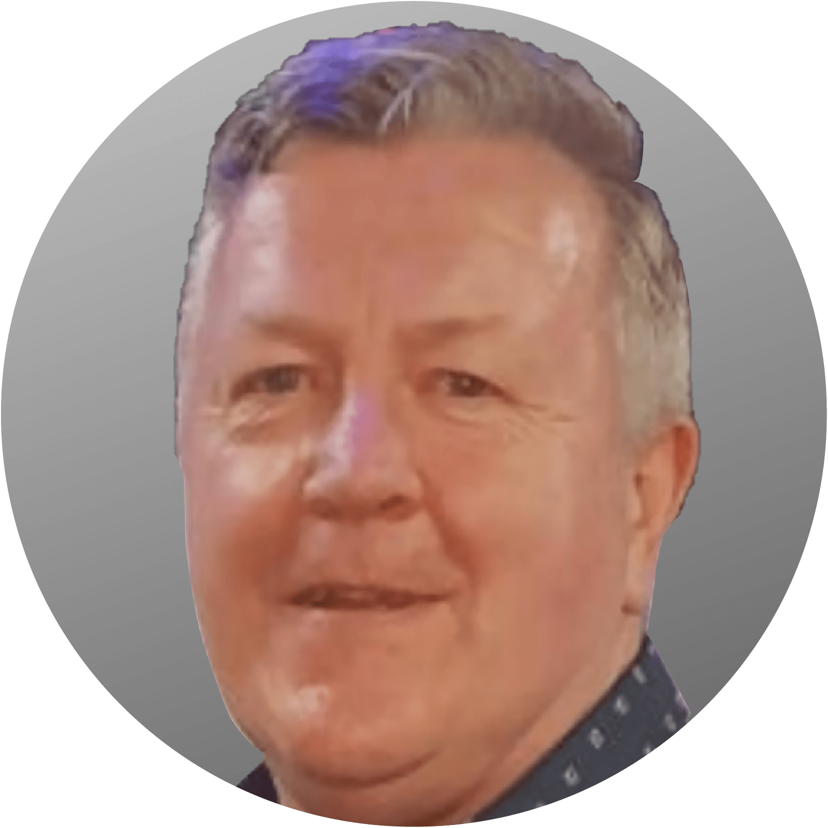 Man with short hair and a collared shirt, smiling, in a circular frame.