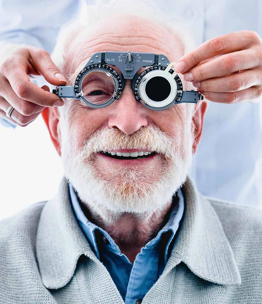 An older man is getting his eyes checked by an ophthalmologist.