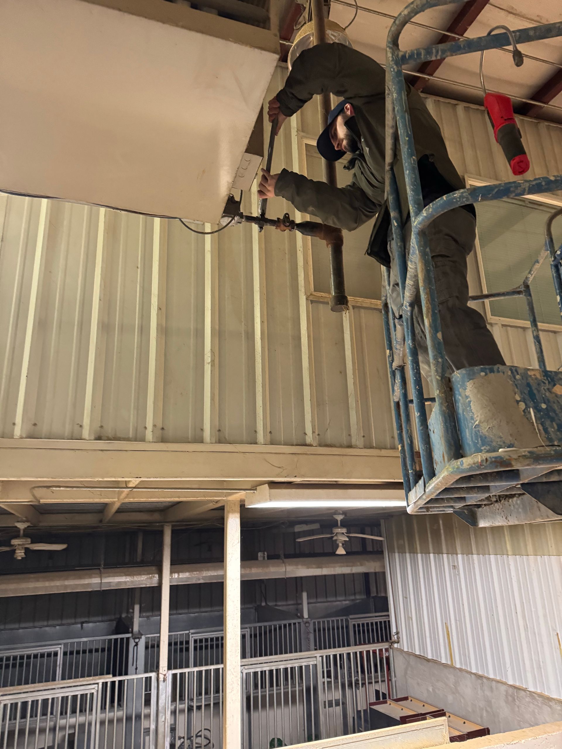 A man is working on the ceiling of a building.