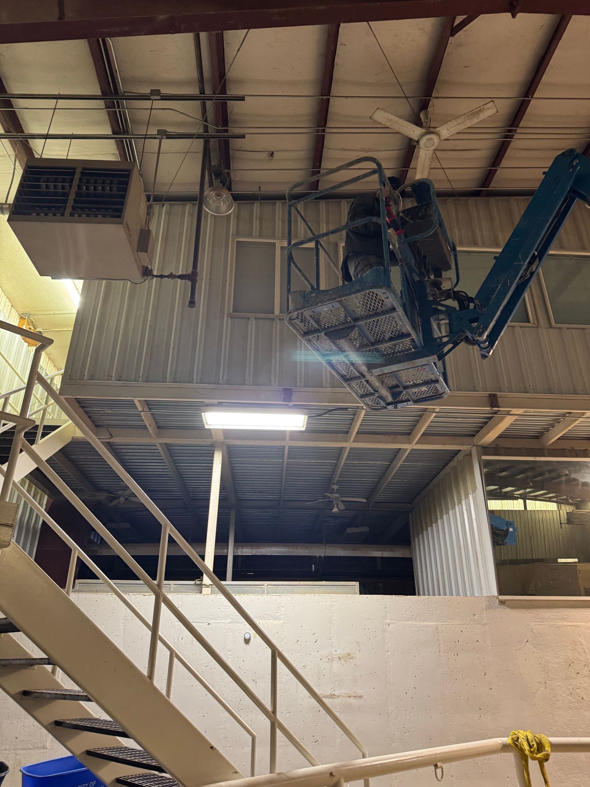 A crane is sitting on top of a metal platform in a building.