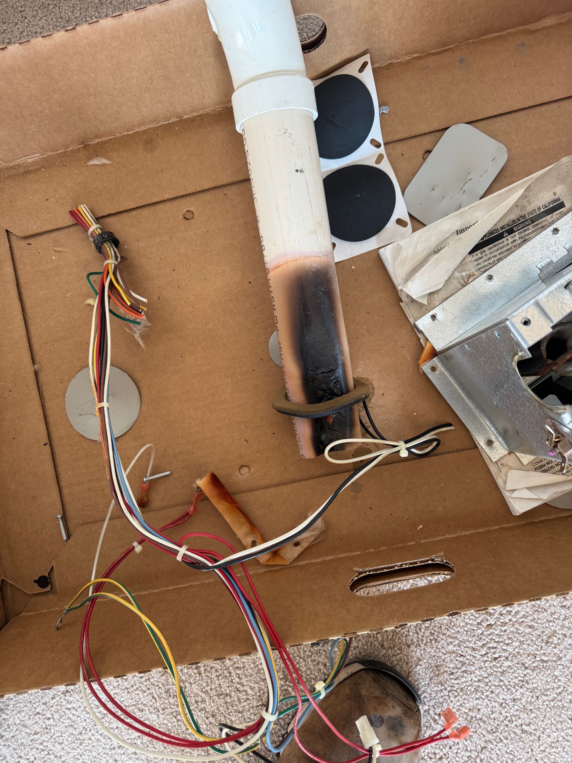 A bunch of wires are laying on a cardboard box