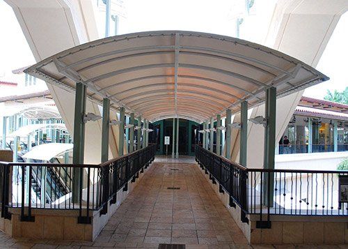 Metal Awning Installation — Mall Hallway With Metal Awning in Palm Beach, FL