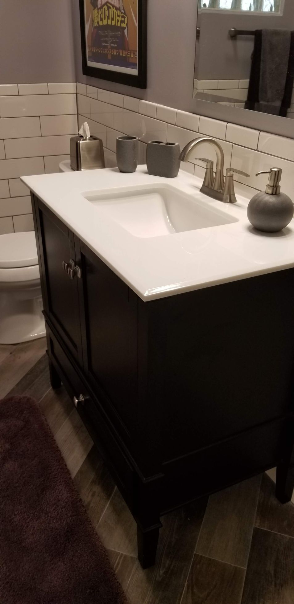A bathroom with a sink , toilet and mirror.