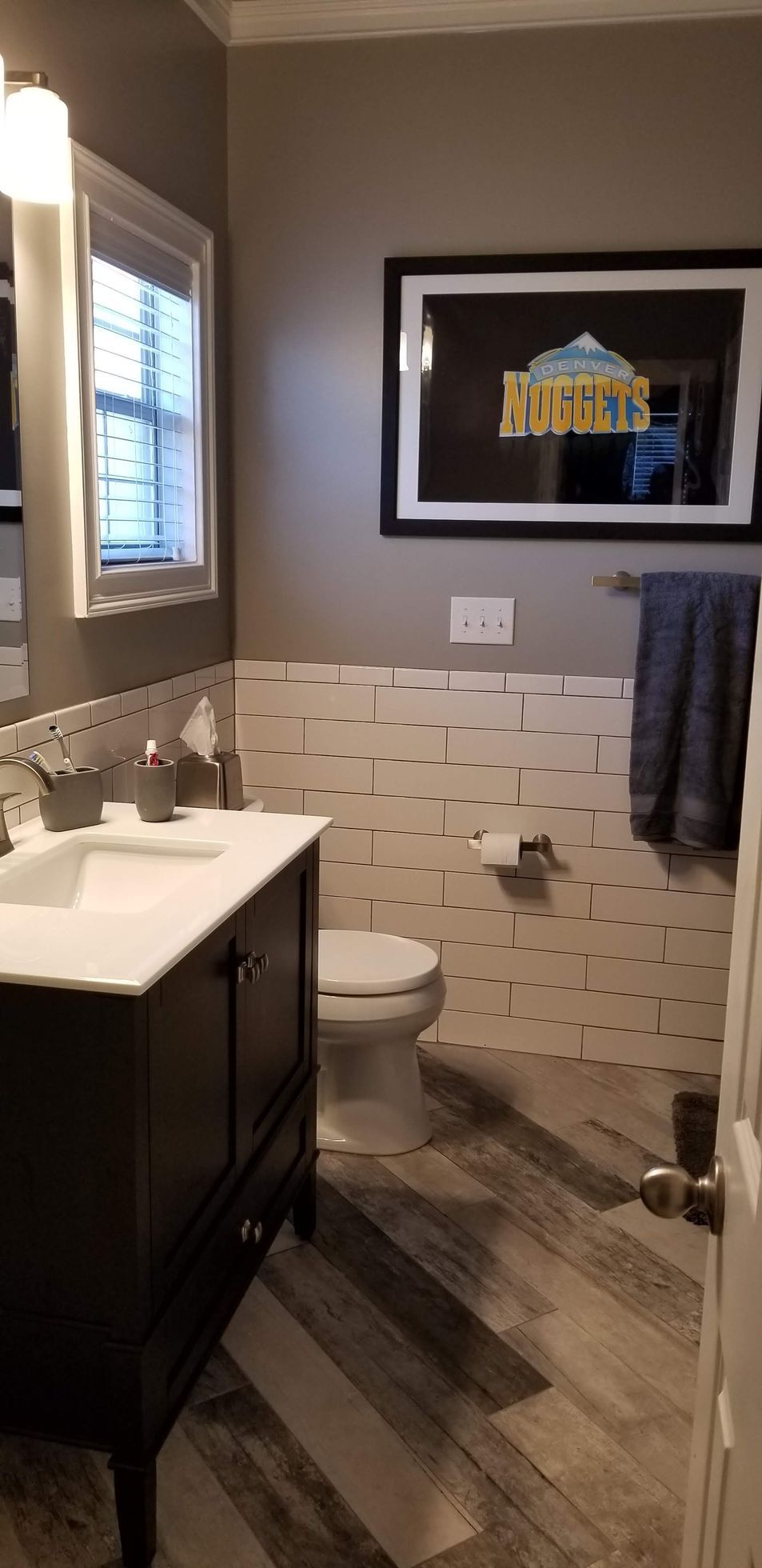 A bathroom with a sink , toilet , and mirror.