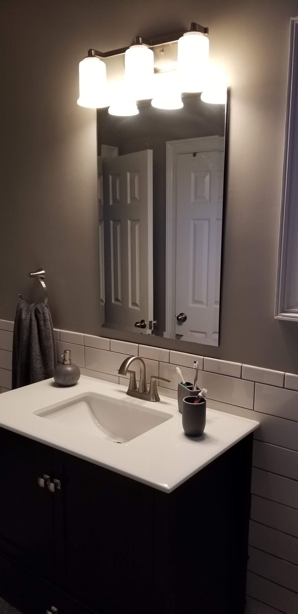 A bathroom with a sink and a mirror.