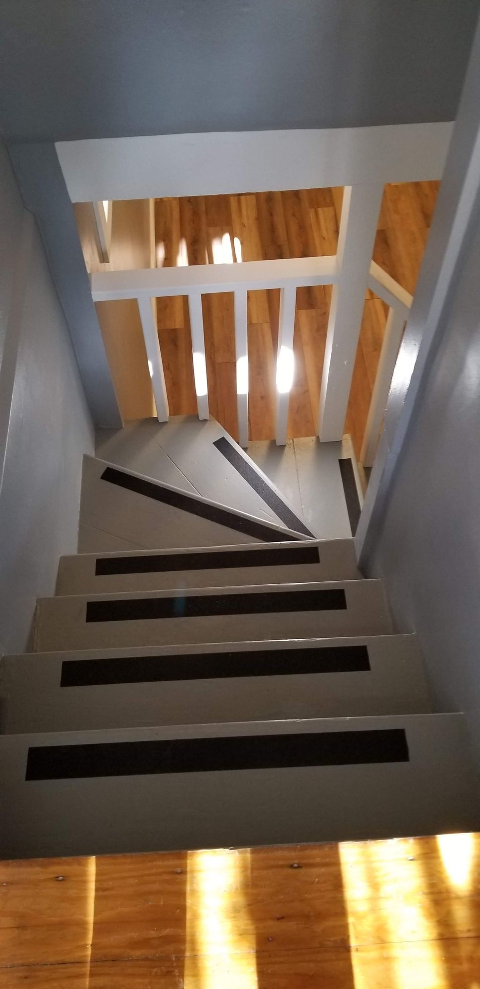 A view of a spiral staircase leading up to a second floor.