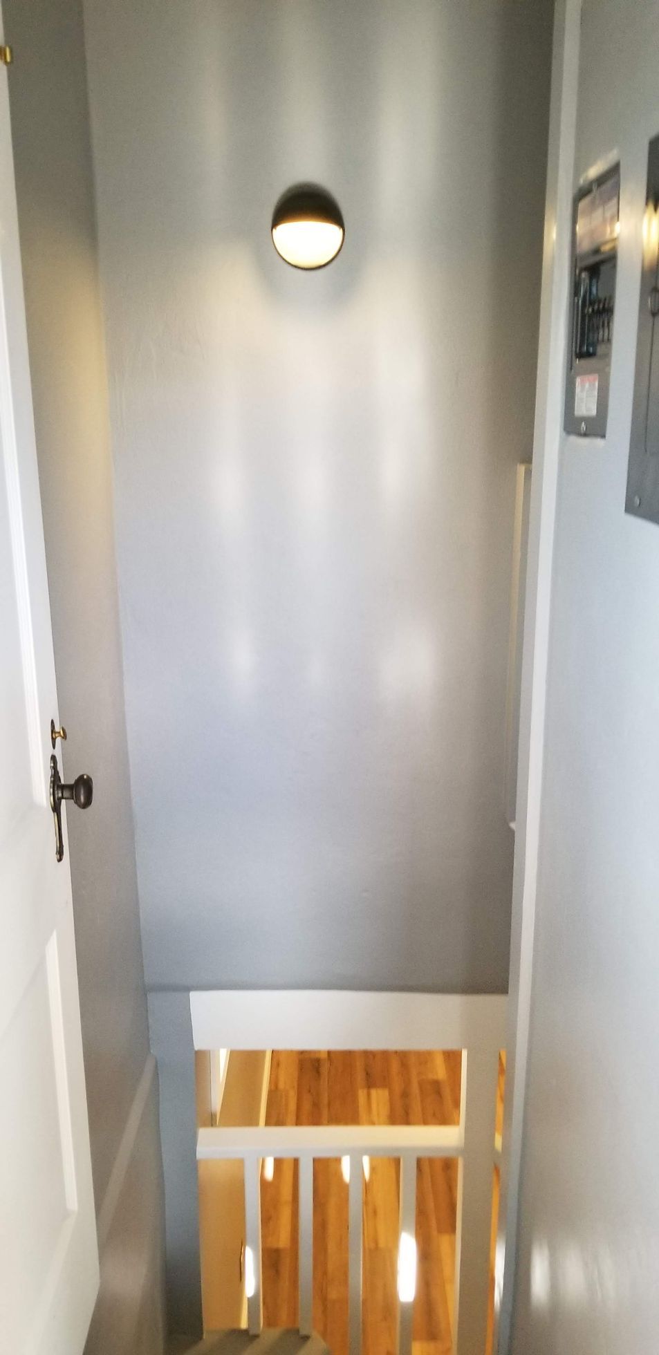 There is a light on the wall above the stairs.